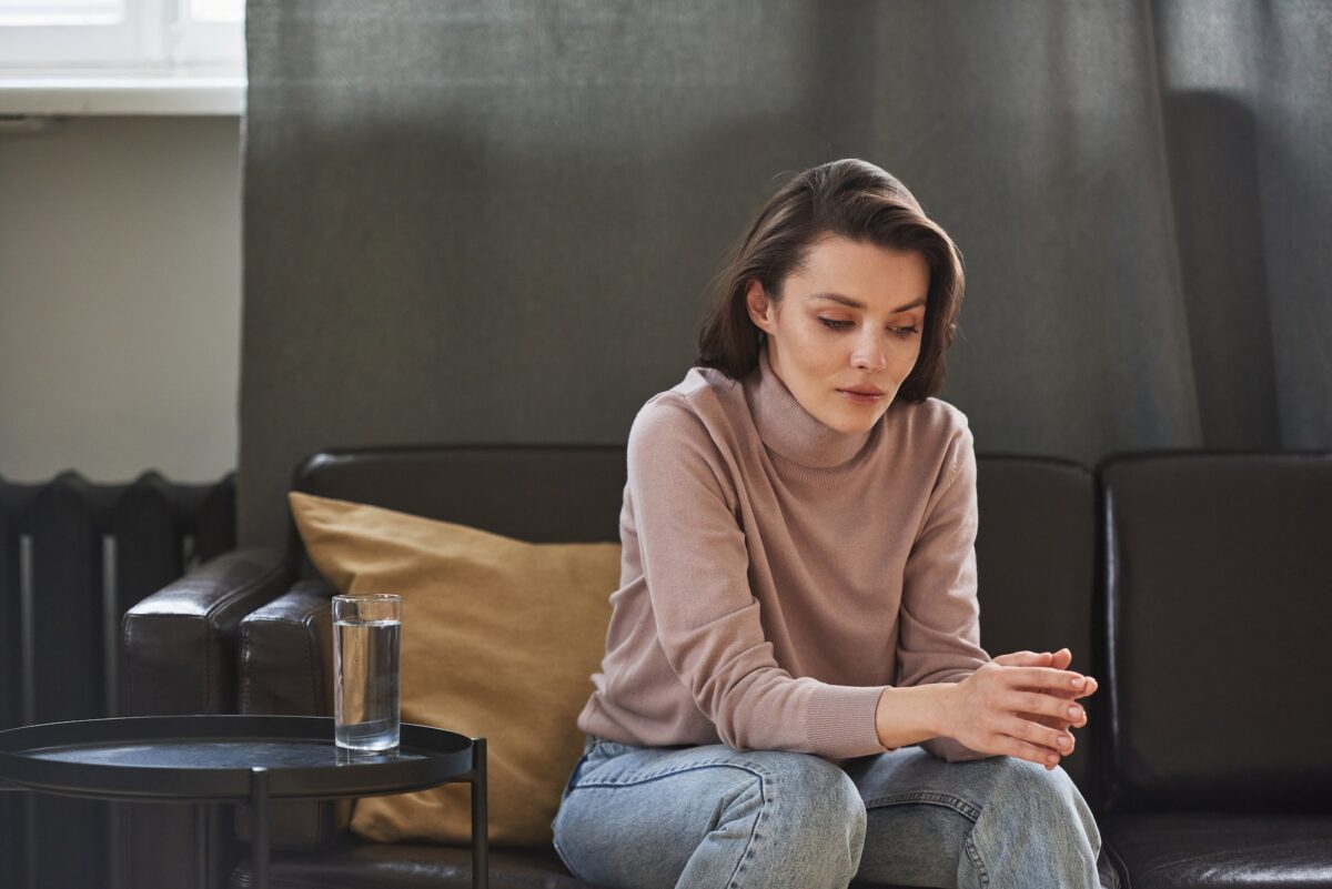 Woman reflecting quietly during a mental health counseling session