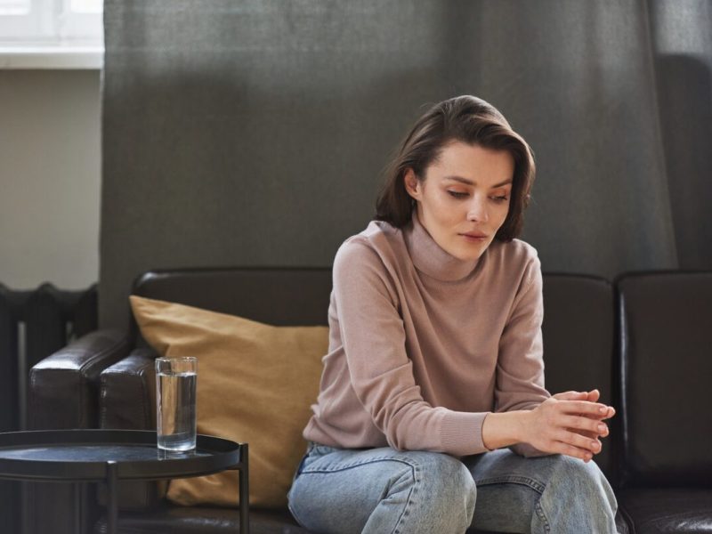 Woman reflecting quietly during a mental health counseling session